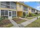 Charming yellow apartments with well-maintained landscaping and inviting walkways at 2155 Wood St # A20, Sarasota, FL 34237