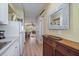Kitchen view leading into the living space with decor, wooden floors, and natural light at 2155 Wood St # A20, Sarasota, FL 34237