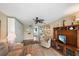 Cozy living room with built-in storage, a ceiling fan, and an entertainment center at 2155 Wood St # A20, Sarasota, FL 34237