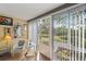 Enclosed patio with comfortable seating, a view of the lush outdoors, and ample natural light at 2155 Wood St # A20, Sarasota, FL 34237