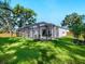 Large, lush backyard featuring a screened-in pool area, offering privacy and ample space for outdoor activities at 2246 Webber St, Sarasota, FL 34239