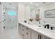 Bright bathroom with double vanity, modern fixtures, and a spacious walk-in shower at 2246 Webber St, Sarasota, FL 34239