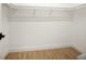 A white walk-in closet includes shelving and wooden floors at 2246 Webber St, Sarasota, FL 34239