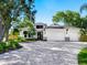 Beautiful two-story home features a well-manicured yard, three-car garage, and a stylish modern design at 2246 Webber St, Sarasota, FL 34239