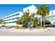 Exterior of a multi-story building with large trees, landscaping, and a circular driveway on a sunny day at 2319 Webber St, Sarasota, FL 34239