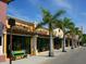 Vibrant restaurant exteriors in a lively neighborhood, featuring awnings, outdoor seating, and lush landscaping at 2319 Webber St, Sarasota, FL 34239