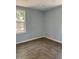 Cozy bedroom with warm wood flooring, neutral walls, and bright natural light from the window at 2404 Lehigh Ave, Bradenton, FL 34207