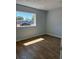 Clean bedroom with wood floors, neutral walls, and a bright window for natural light at 2404 Lehigh Ave, Bradenton, FL 34207