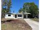 Well-maintained single-story home with a lush green lawn and a charming, welcoming entrance at 2404 Lehigh Ave, Bradenton, FL 34207