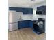 Modern kitchen with stainless steel appliances, blue cabinets, stylish backsplash, and wood-look flooring at 2404 Lehigh Ave, Bradenton, FL 34207