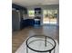 Bright, modern kitchen with stainless steel appliances and blue cabinets, flowing into the dining area at 2404 Lehigh Ave, Bradenton, FL 34207