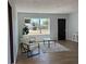 Inviting living space with wood floors, neutral tones, modern chairs, a coffee table, and bright natural light at 2404 Lehigh Ave, Bradenton, FL 34207