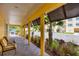 Relaxing walkway with brick pavers, columns, tropical landscaping, and seating at 242 Hidden Bay Dr # 302, Osprey, FL 34229