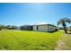 Spacious backyard features a screened lanai and lush lawn, perfect for outdoor entertaining at 25422 Aysen Dr, Punta Gorda, FL 33983