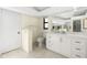 Well-lit bathroom with tile floor, marble counters, and updated fixtures at 25422 Aysen Dr, Punta Gorda, FL 33983
