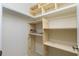 Walk-in closet featuring wood shelving at 25422 Aysen Dr, Punta Gorda, FL 33983