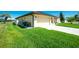 Well-maintained home with a two-car garage, lush green lawn, and meticulous landscaping at 25422 Aysen Dr, Punta Gorda, FL 33983