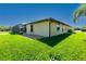 Well-maintained backyard featuring a screened lanai and green grass at 25422 Aysen Dr, Punta Gorda, FL 33983