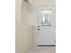 View of the front entry door with decorative glass, and neutral flooring at 25422 Aysen Dr, Punta Gorda, FL 33983