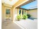Inviting front porch with decorative plants, a secured front door, and white gravel at 25422 Aysen Dr, Punta Gorda, FL 33983