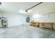 Spacious two-car garage with storage cabinets, workbench, and plenty of room for vehicles at 25422 Aysen Dr, Punta Gorda, FL 33983