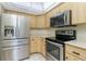 Kitchen featuring stainless steel appliances and light wood cabinets at 25422 Aysen Dr, Punta Gorda, FL 33983