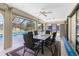 Bright lanai features a dining set and ceiling fan, perfect for relaxing near the pool and enjoying the outdoors at 25422 Aysen Dr, Punta Gorda, FL 33983