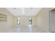 Living room with tiled floor and two windows at 25422 Aysen Dr, Punta Gorda, FL 33983