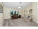 The spacious living room with carpet, a ceiling fan and a comfortable sitting area at 25422 Aysen Dr, Punta Gorda, FL 33983