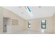 Bright living room features vaulted ceilings, built-in shelves, and tile floors at 25422 Aysen Dr, Punta Gorda, FL 33983