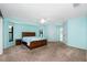 Spacious main bedroom with ensuite bathroom, large bed, and natural light at 25422 Aysen Dr, Punta Gorda, FL 33983