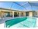 Inviting screened-in pool, ideal for outdoor entertaining and enjoying the serene backyard views at 25422 Aysen Dr, Punta Gorda, FL 33983