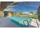 Sparkling screened-in pool, perfect for swimming and relaxation with landscaped views at 25422 Aysen Dr, Punta Gorda, FL 33983