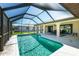 Enjoy a refreshing swim in this sparkling pool, enclosed in a screened lanai with serene outdoor views at 25422 Aysen Dr, Punta Gorda, FL 33983