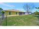 Side view of home with well-maintained lawn and backyard featuring ample space and clean landscaping at 27142 Villarrica Dr, Punta Gorda, FL 33983