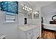 Bathroom vanity with a well-lit mirror plus view to the bedroom and storage closet at 27142 Villarrica Dr, Punta Gorda, FL 33983