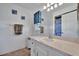 Bathroom with a well-lit vanity and white cabinets plus decor adding a touch of fun to the room at 27142 Villarrica Dr, Punta Gorda, FL 33983