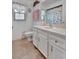 Bathroom features a vanity, framed mirror and toilet at 27142 Villarrica Dr, Punta Gorda, FL 33983