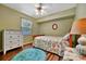 Cozy bedroom with wood-look flooring, dresser and a ceiling fan at 27142 Villarrica Dr, Punta Gorda, FL 33983