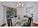 Cozy dining room with a view of the screened lanai, chandelier, and modern appliances at 27142 Villarrica Dr, Punta Gorda, FL 33983