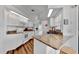 Bright kitchen featuring white appliances and cabinets, granite countertops, and a breakfast bar at 27142 Villarrica Dr, Punta Gorda, FL 33983