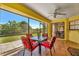 Screened lanai featuring a ceiling fan offers expansive backyard views, perfect for entertaining at 27142 Villarrica Dr, Punta Gorda, FL 33983