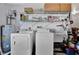 Laundry room featuring a washer, dryer, and storage shelves at 27142 Villarrica Dr, Punta Gorda, FL 33983