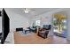 Bright living room featuring vaulted ceilings, wood floors, and comfortable seating at 27142 Villarrica Dr, Punta Gorda, FL 33983