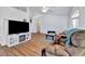 Bright living room featuring vaulted ceilings, wood floors, and a comfortable seating area at 27142 Villarrica Dr, Punta Gorda, FL 33983