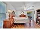 The well-lit main bedroom has hardwood floors and sliding glass door to a screened-in patio at 27142 Villarrica Dr, Punta Gorda, FL 33983