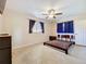 Bright bedroom featuring a ceiling fan, neutral walls, dark blue curtains and wood furniture at 2845 64Th S Ter, St Petersburg, FL 33712