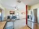 Eat-in kitchen features stainless steel refrigerator, dining area and sliding glass door to backyard at 2845 64Th S Ter, St Petersburg, FL 33712