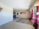 Bright living room with terrazzo floors, large windows, and an adjacent dining area at 2845 64Th S Ter, St Petersburg, FL 33712