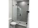 Modern bathroom showcasing a glass shower with gray tile and modern fixtures at 3204 W Grace St, Tampa, FL 33607